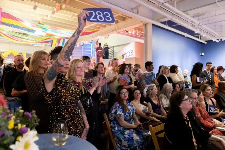Art Bash guests taking part in a live art auction at Artspace