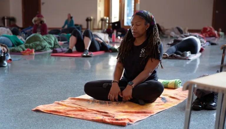 woman meditating on mat