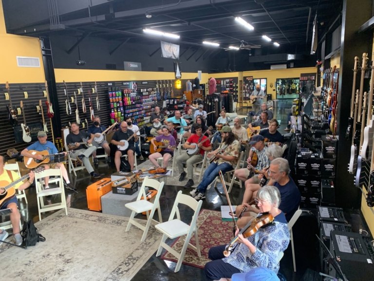 Musicians at a PineCone beginners bluegrass jam at Harry’s Guitar Shop